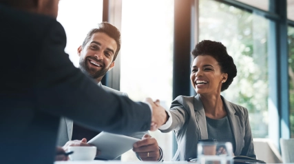 Happy business people, handshake and meeting in teamwork for partnership or collaboration in boardroom. Woman person shaking hands in team recruiting, introduction or b2b agreement at the workplace.